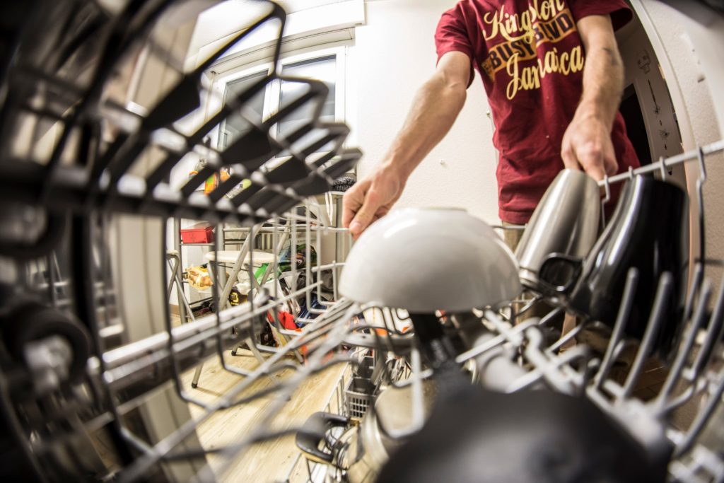A man emptying a dishwasher