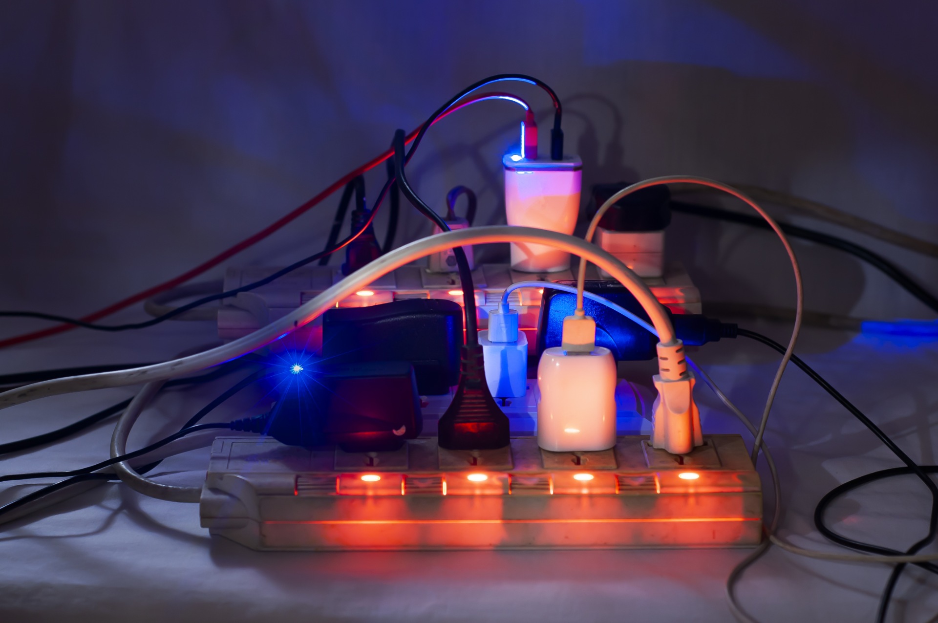 Power strip with a bunch of cords plugged into it